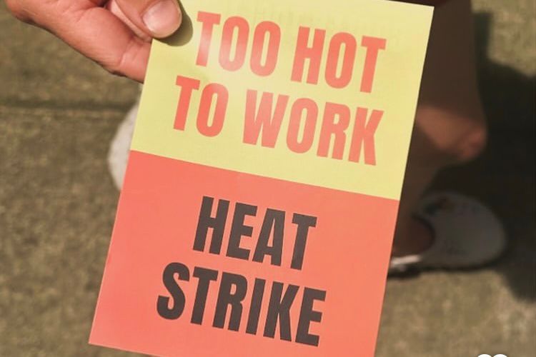 Hand holding flyer saying 'too hot to work - heat strike'