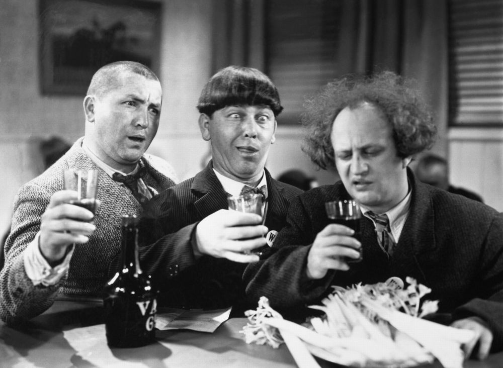 The Three Stooges (Larry, Moe, and Curly) each taking a drink of alcohol