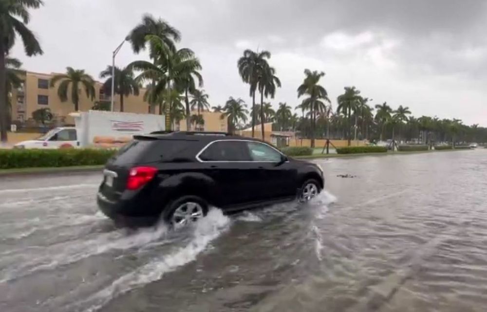 US-FL: Motorists drive along waterlogged street in Broward County after storms cause flooding