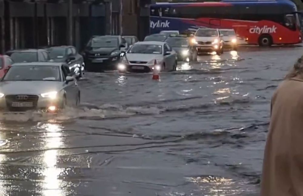 IRELAND: Motorists navigate flooded streets in Cork after heavy downpours