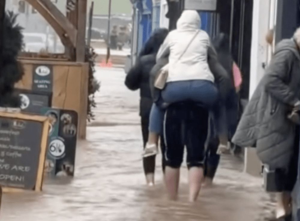 IRELAND: Pedestrians navigate flooded street as weather warnings issued in Ireland