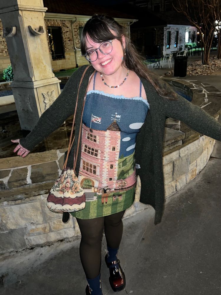 Clare in the same fit showing off her purse to go with it