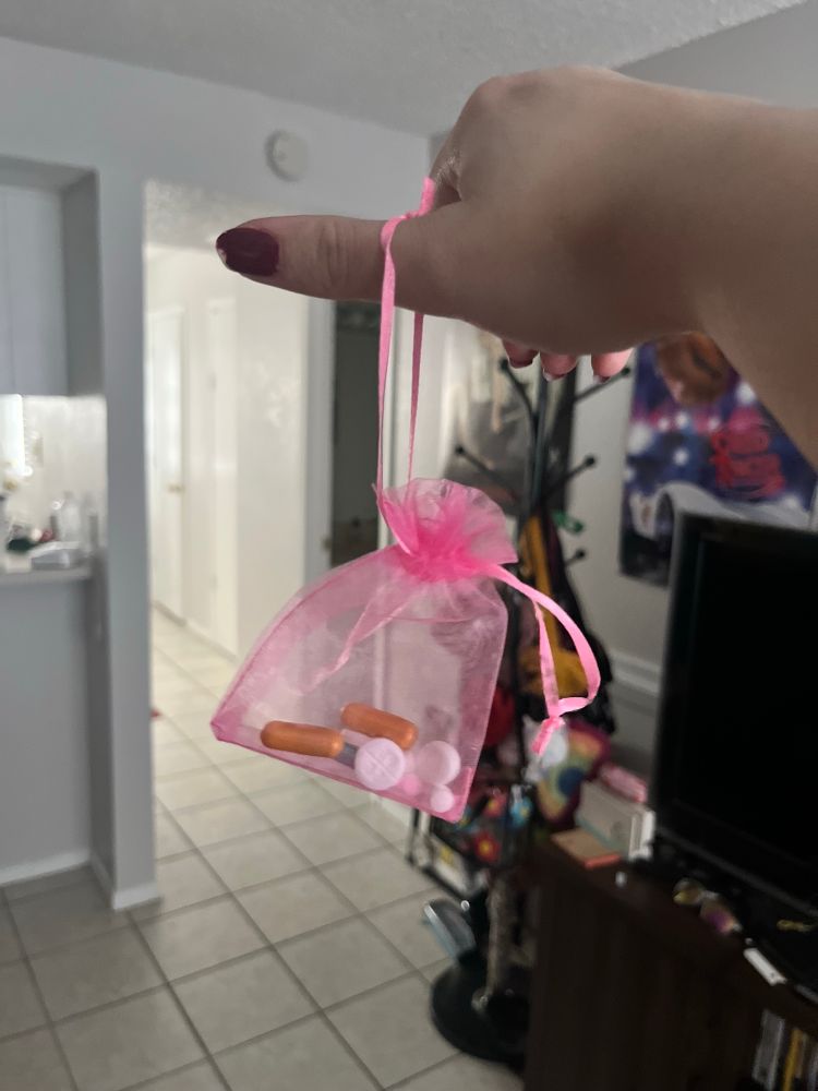 My pills in a small one of those ribbon mesh string bags that is pink and you can see them