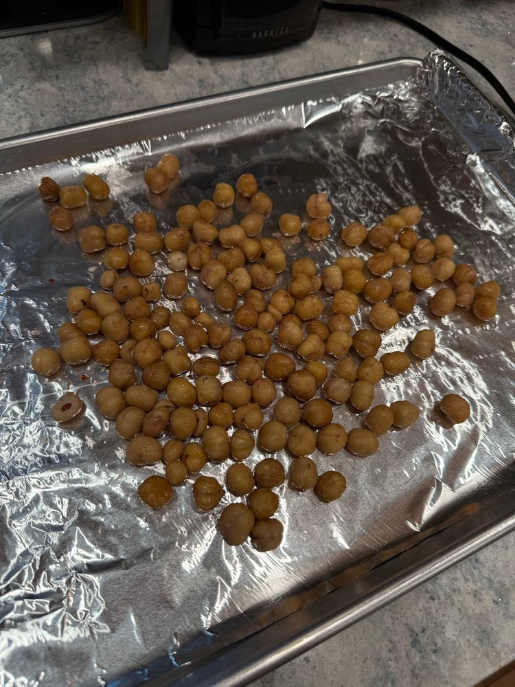 A pan of peeled, waterlogged hazelnuts. 