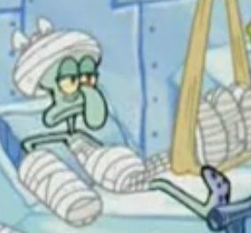 Squidward laying in a hospital bed as his entire body is bandaged, and he has a depressed expression
