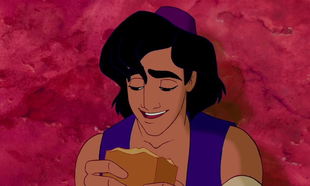 Aladdin from the animated movie, looking at a piece of bread that looks very tasty