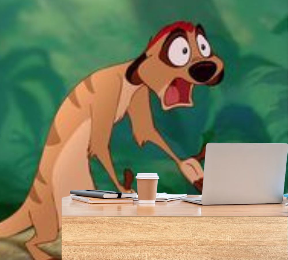 timon the meerkat from the lion king, jaw agape, mouth open and hands out in stunned disbelief as he looks at a laptop in front of him