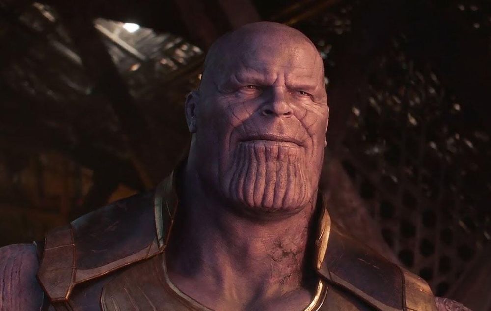 thanos sitting as he looks relieved, looking out at a peaceful sunrise after having accomplished his goals