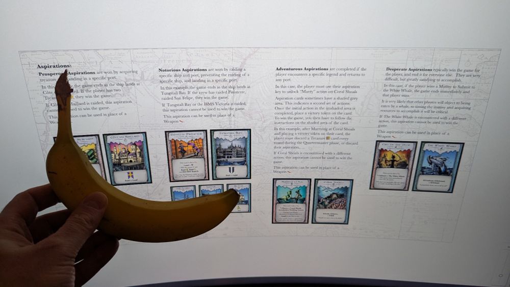 Screenshot of board game rules, with banana for scale. 