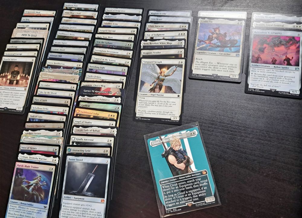 Photo of Magic cards assorted on a table. It is a mono-white equipment deck with Cloud, Midgar Mercenary as the commander.