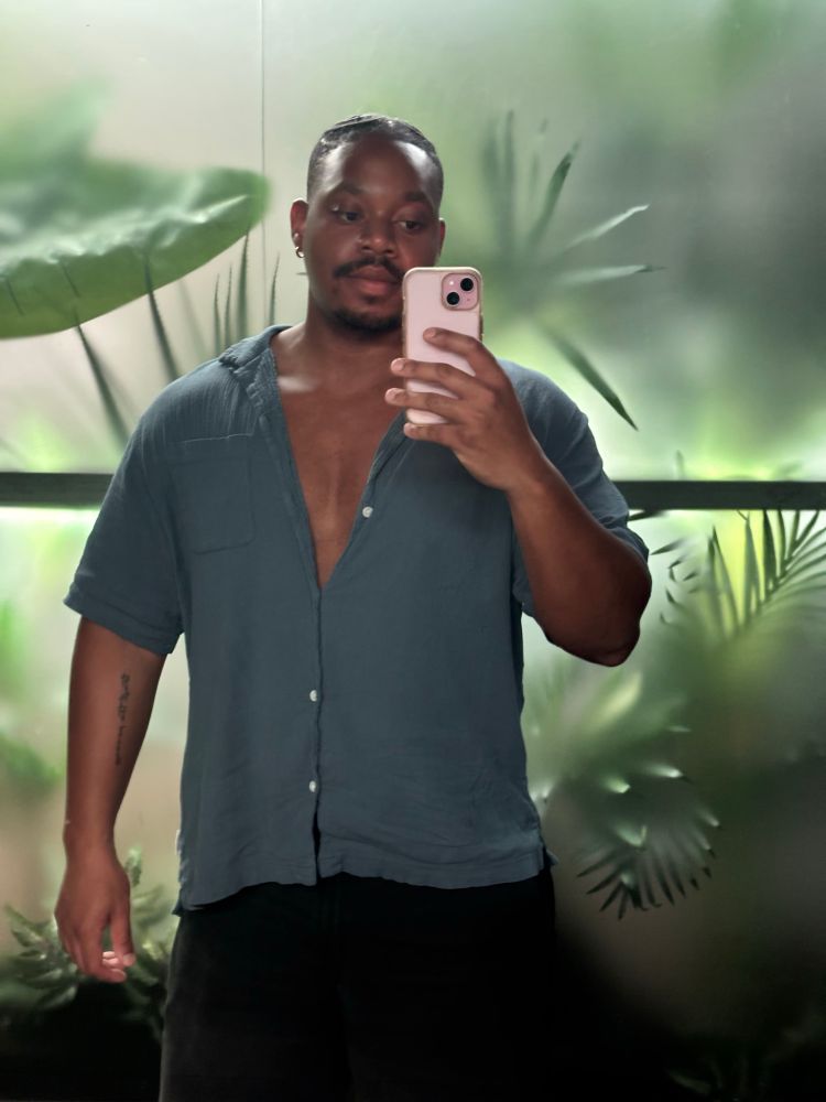 me taking a mirror selfie in the bathroom of a bar, with more of my face showing