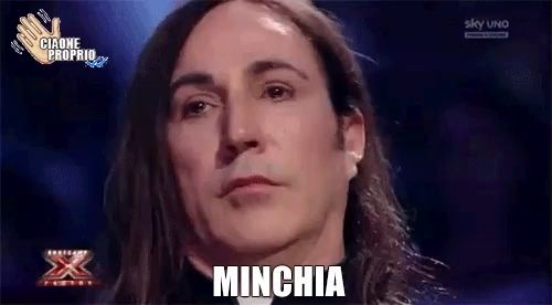 a man with long hair says minchia in a foreign language