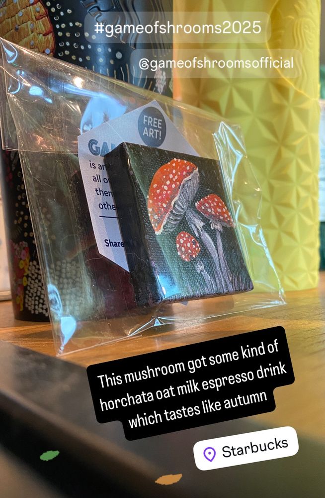 A small mushroom painting hidden amongst some Starbucks cups.