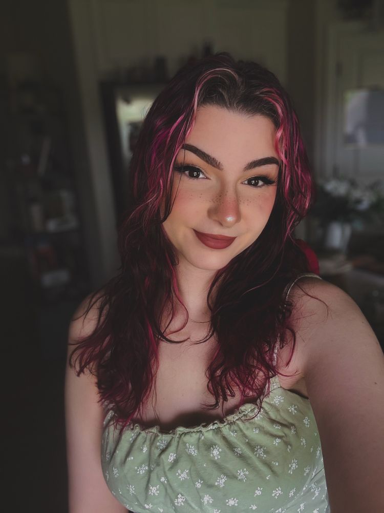 a selfie of bee wearing a green tank top