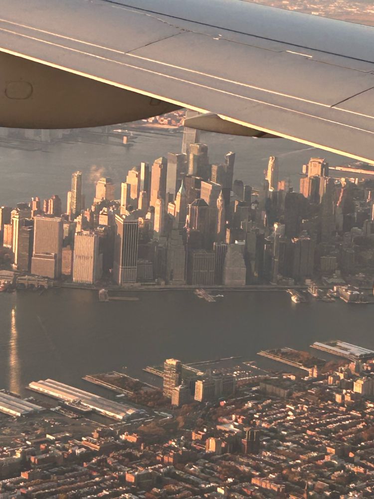 A shot of the southern part of the New York City skyline from a plane. 