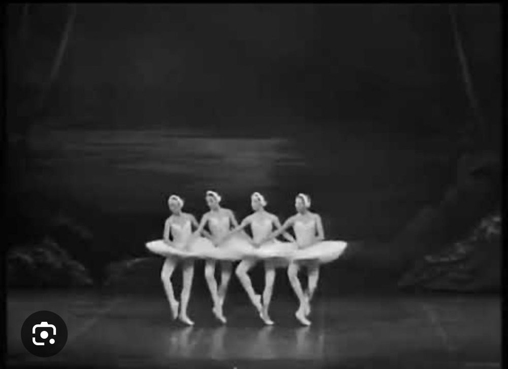 Four dancers performing Swan Lake. 