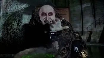 The Penguin from Batman Returns holding a severed hand