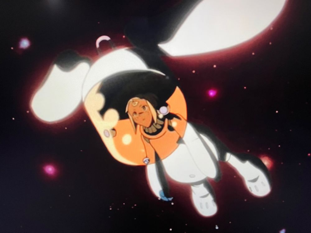 continuation of previous image, the cartoon face clears to reveal it’s a spacesuit helmet faceplate/bowl, & the suit is worn by Lal’C