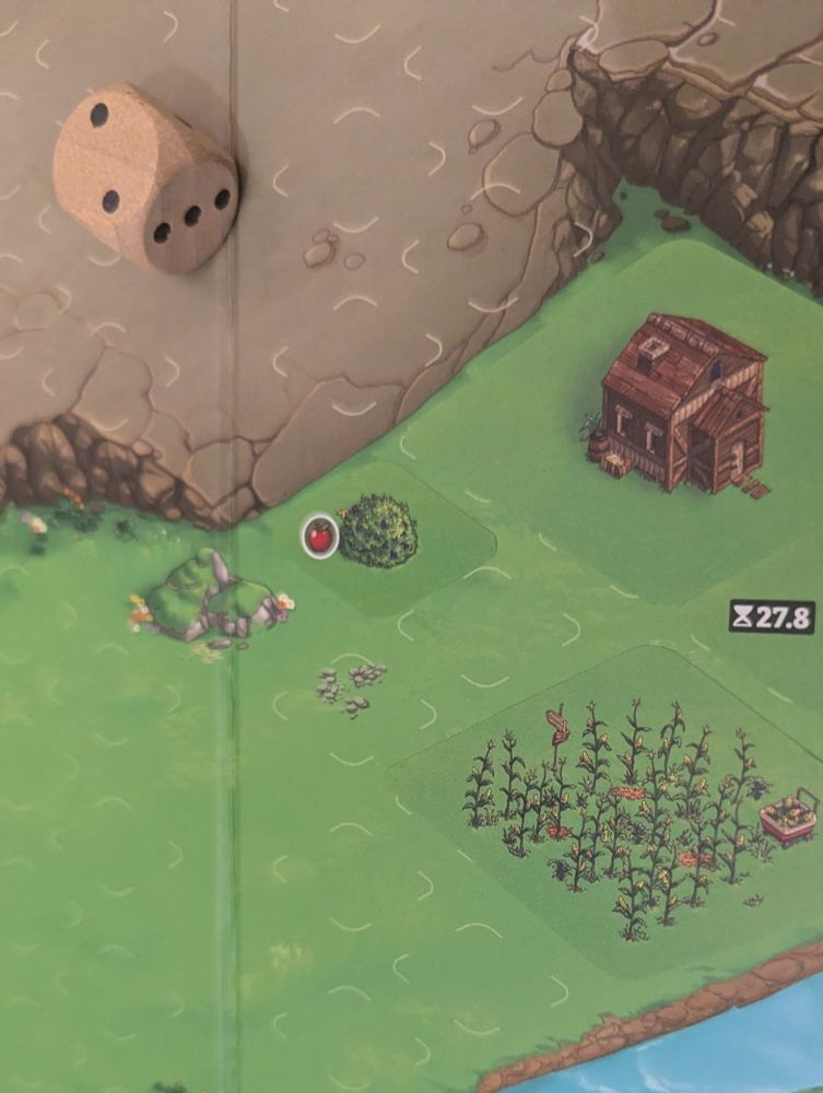 Gameboard for Cozy Stickerville. Detailed empty map of grassy terrain near a mountain face, and a visible sliver of a river. A house and garden and berry bush are visible. All three are stickers placed during setup and early gameplay. 