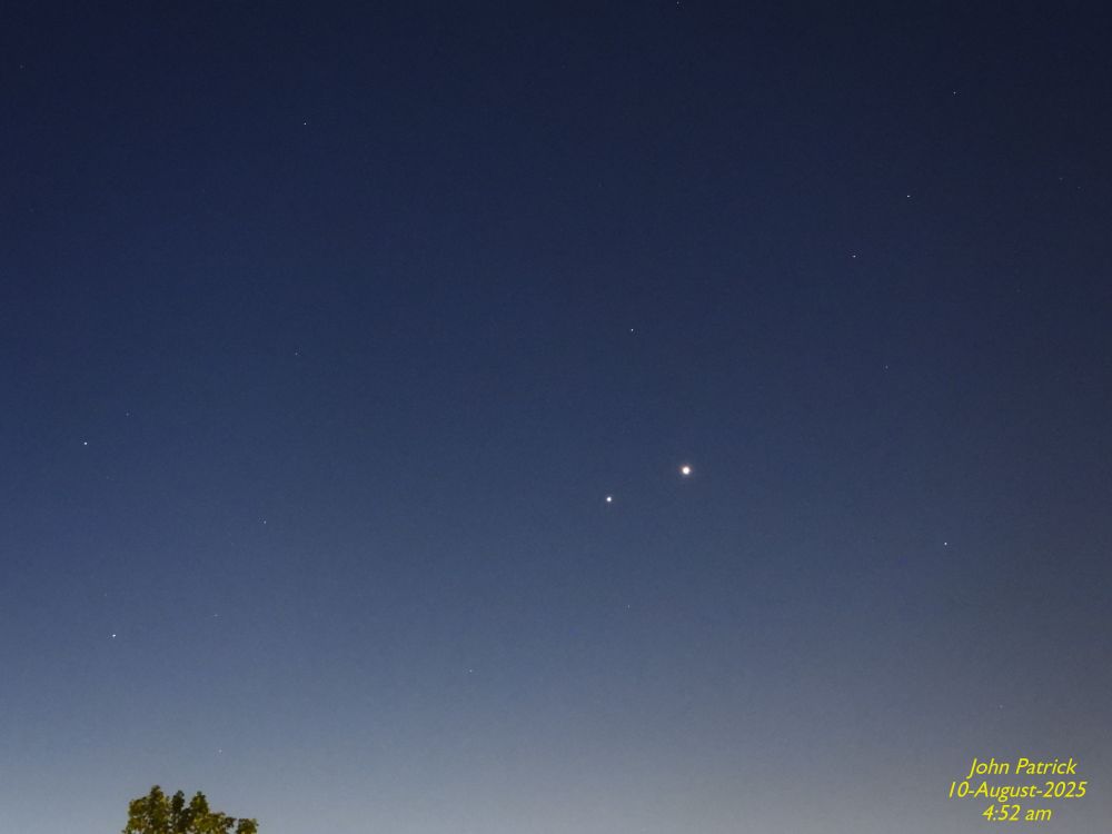 1 of 2
Photo: An image of the predawn sky already lightening at the bottom of the picture to herald the on coming dawn.   In the center of the picture are two white dots.  One to the right and slightly larger is the planet Venus. The other is slightly lower in the sky and is the planet Jupiter.  Around these two planets small dots the size of pin pricks are the stars in the constellation Gemini 
