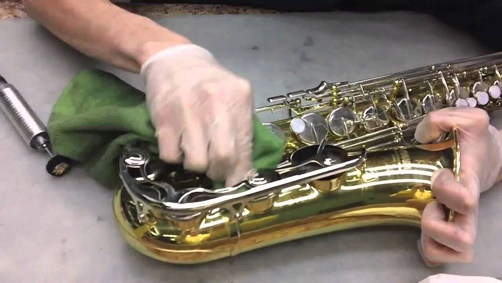 Someone cleaning their saxophone