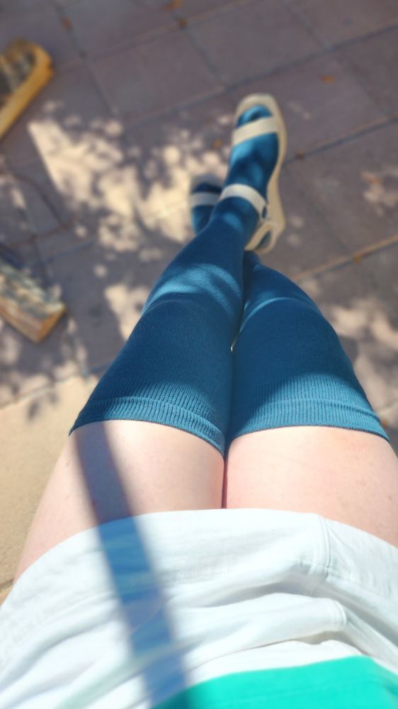 a picture of my legs. I'm wearing a white skirt, dark green thigh high socks and a pair of light brown, open toed heel sandals