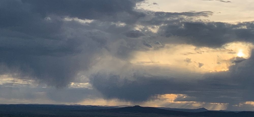 Big cloud bursts and light over mountains