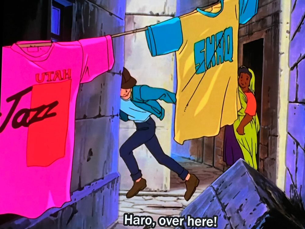 A frame from Mobile Suit Victory Gundam showing Utah Jazz and Shaq shirts hanging on a clothesline in a space colony