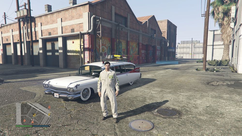 A screenshot from GTA V Online featuring a character in a light coloured jumpsuit with yellow and black striping and a logo that reads Ghosts Exposed above zip pockets on the front. The car from the previous post appears in the background, now painted white with red fins and silver trim. It also has a roof rack, some roof lights and a number plate that reads ECTONE1 in blue text on a white background.