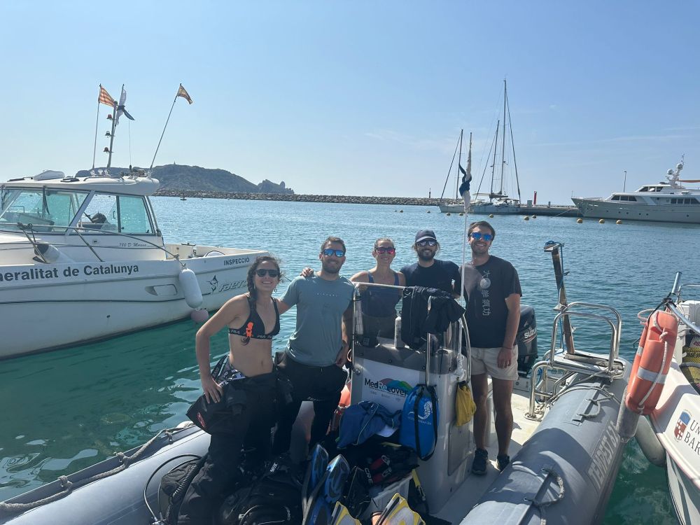 Diving team posing for a group picture from the zodiac