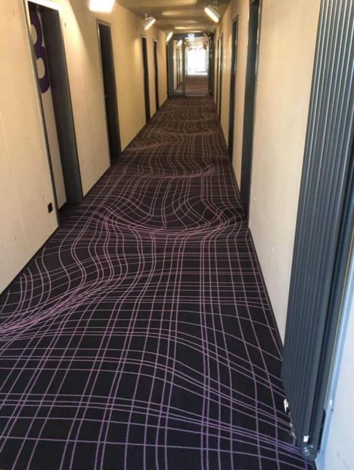 A corridor with a wobbly field that looks very mathematically structured but it's just uneven.