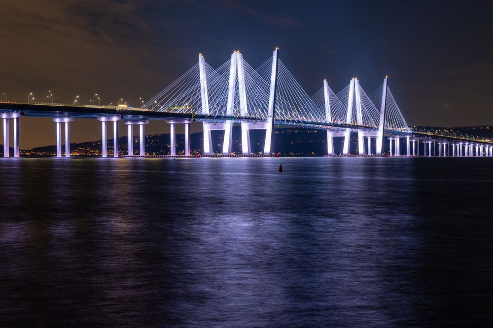 The Gov. Mario M. Cuomo Bridge with all of its lights on at during the night. 