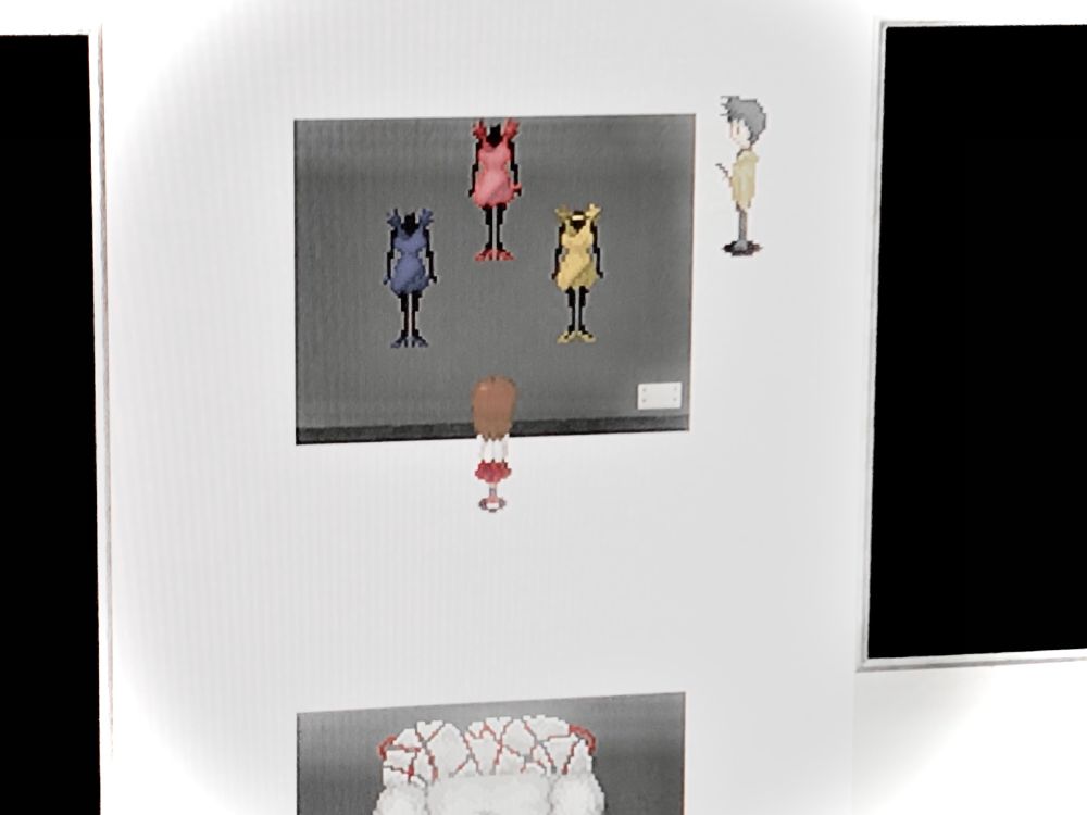 Ib!! A girl stands in front of three statues. The statues are well-dressed in blue, red, and yellow, respectively; a short dress and matching heels for each. They’re made of some dark, dense material, that reflects just a trace of light. Bizarrely, the statues all lack heads, and end at the neck.