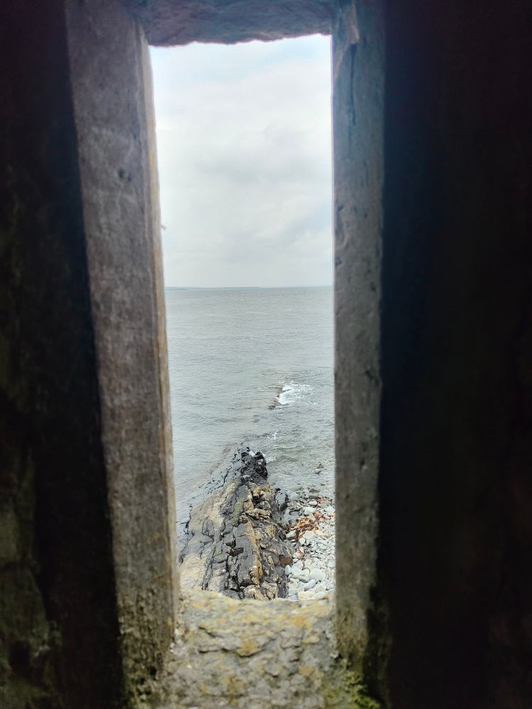A photo taken from the lookout tower in  Carrigaholt Castle looking out over the Shannon Estuary.  This shot looks out to sea.