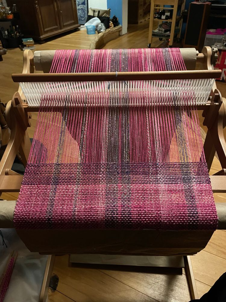 Scarf in progress on a rigid heddle loom, the project seen from above. 