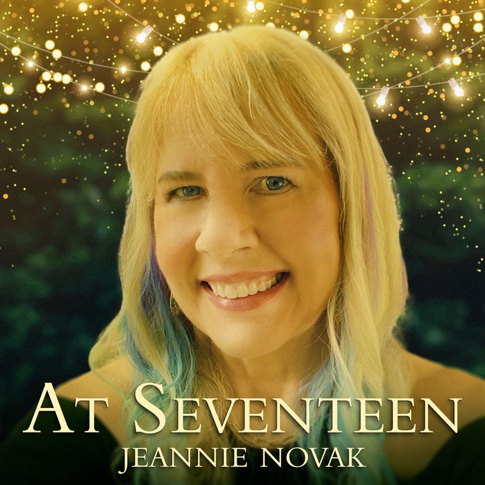 Cover image for “At Seventeen” single depicting photo of Jeannie Novak against a backdrop of glowing lights and green foliage.