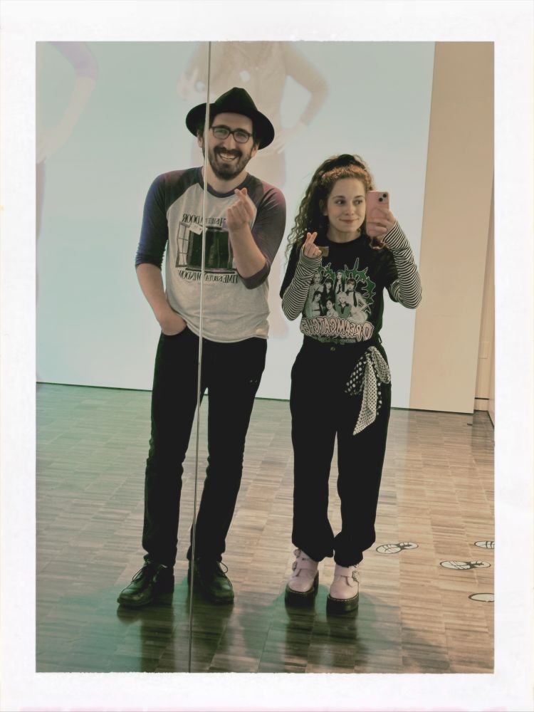A shot of max and I in the mirror holding up finger hearts and smiling! 