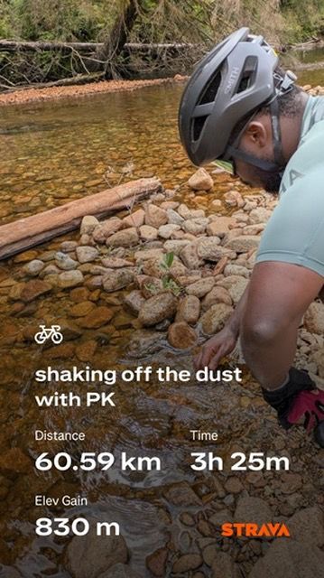 cyclist kneeling my a stream with strava stats showing a 60.59 km ride 