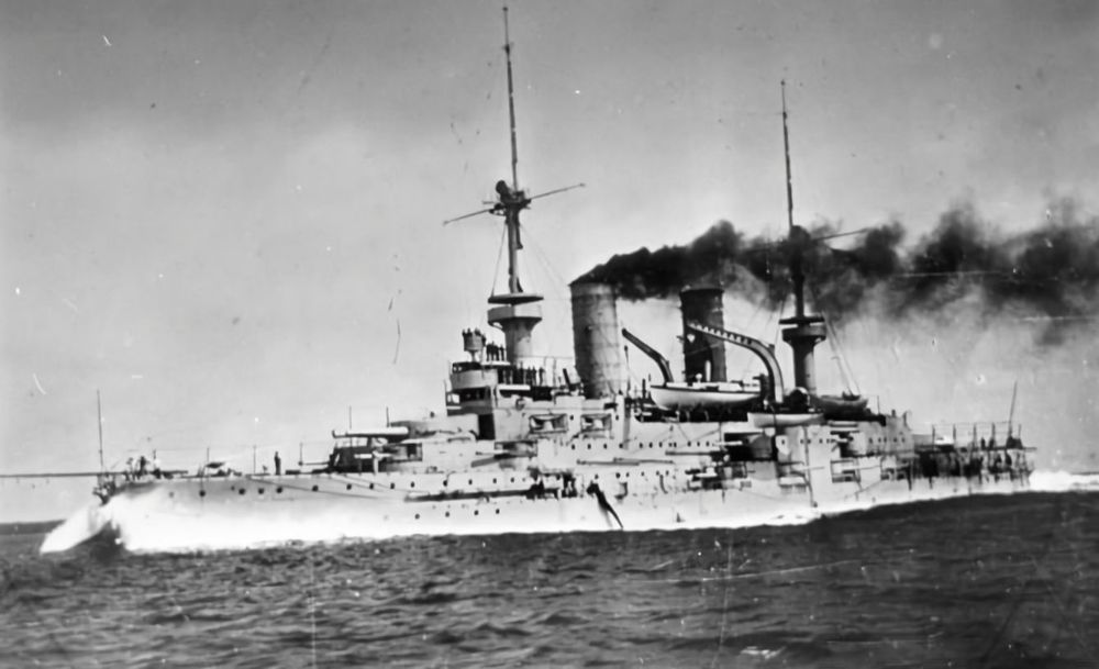 The lead ship of her class of five pre-dreadnought battleships built for the Imperial German Navy, SMS Wittelsbach was laid down in 1899 and completed in October 1902. Along with her sister ships Wettin, Zähringen, and Mecklenburg, she served in I Squadron for the duration of her peacetime career. Her other sister, Schwaben was used as a training ship to modernize the training unit of the German fleet.

Decommissioned in 1910, but reactivated a year later, she served as a training ship until 1914. Brought back to active duty by the start of World War One, Wittelsbach served with IV Battle Squadron. The ship served in the Baltic Sea, including during the Battle of the Gulf of Riga in August 1915, but saw no combat with Russian forces. By late 1915, crew shortages and the threat from British submarines forced the Kaiserliche Marine to withdraw older battleships like Wittelsbach. The ship then saw service in auxiliary roles, first as a training ship and then as a ship’s tender. After the war, she was converted into a tender for minesweepers in 1919. In July 1921, the ship was sold and broken up for scrap metal.