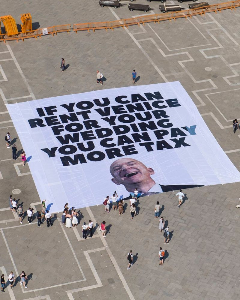 A banner that reads "if you can rent Venice for your wedding you can pay more tax"