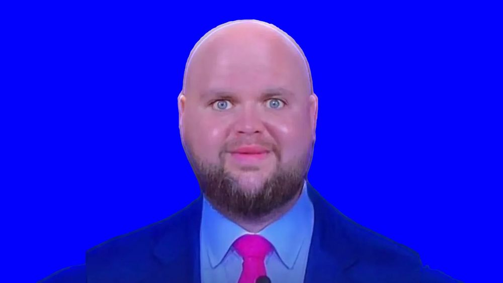 JD Vance with a massive bald head on an electric blue background
