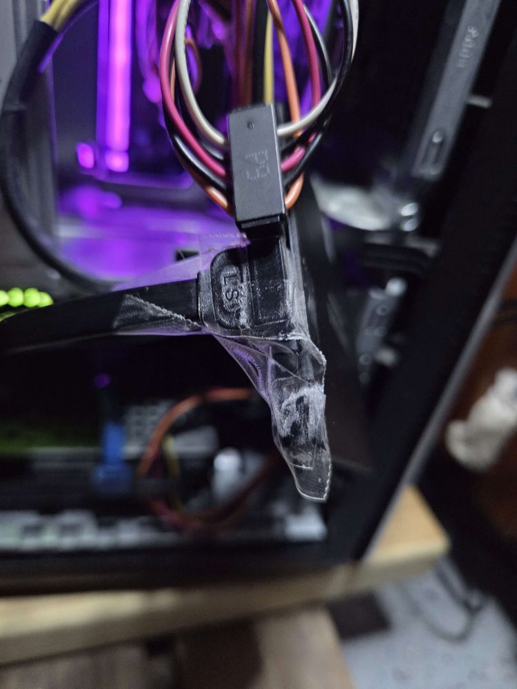 an SSD hard drive with a connector held on with 6 pieces of gorilla tape wrapped around.