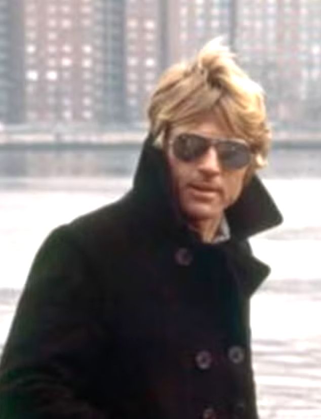 Photograph of Robert Redford wearing an upturned coat and sunglasses in Three Days of the Condor
