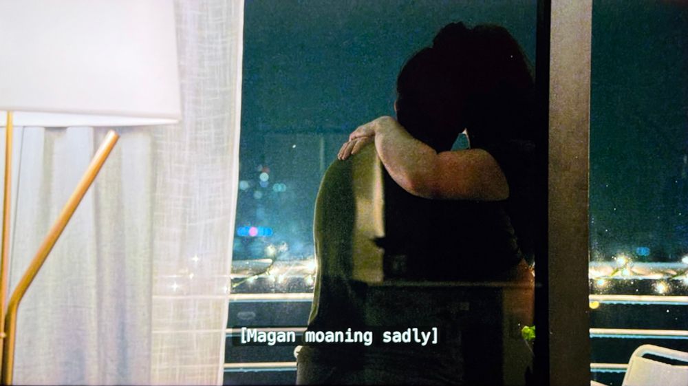 a still from the 2nd season of the ultimatum of two women holding each other, subtitled “Magan moaning sadly”