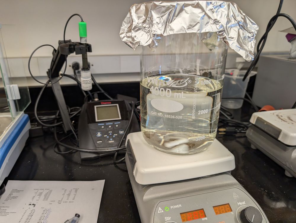 2 liters of sweat solution in a large beaker in a laboratory.