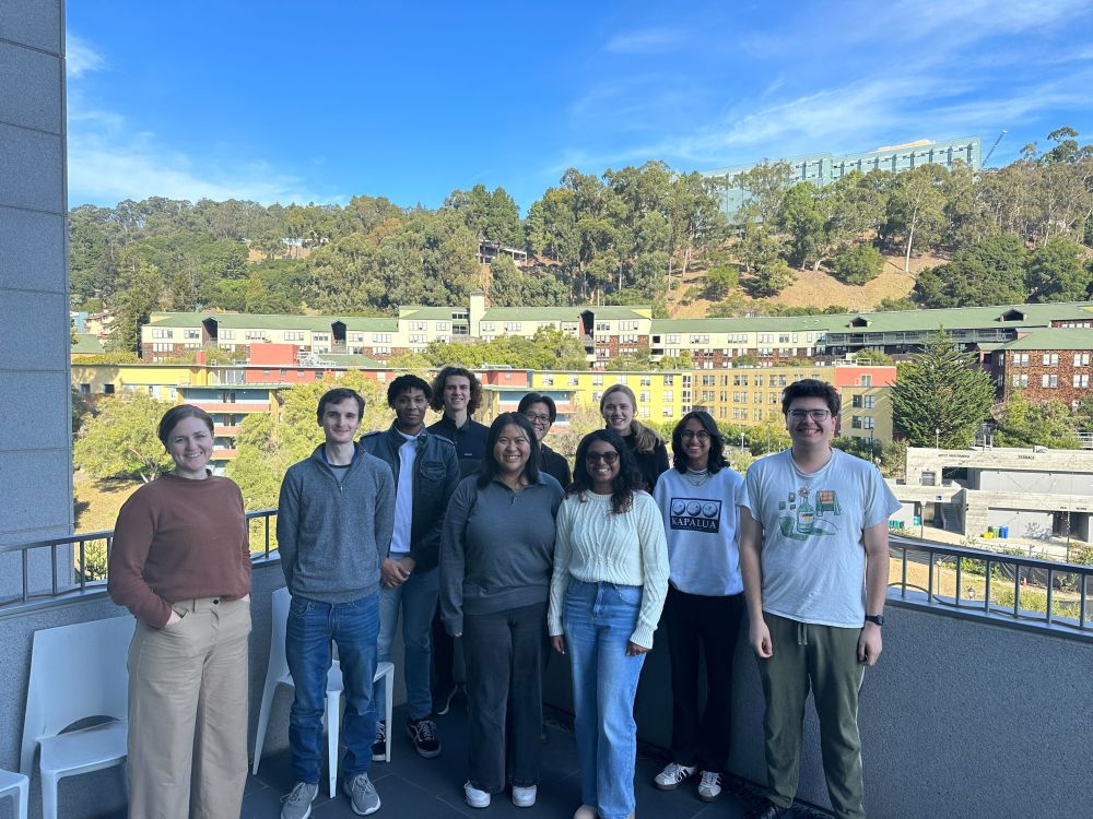 The Lucas lab gathered outside on a balcony overlooking Berkeley. 