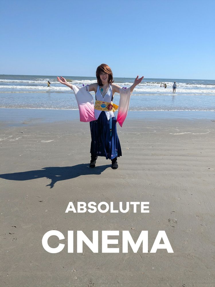 Me in my Yuna cosplay on the beach with my hands raised, with the meme text "absolute cinema" beneath it