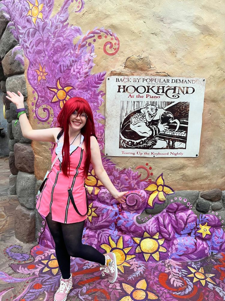 My cosplay of Kairi from Kingdom Hearts. I am standing in front of the Rapunzel bathrooms at Disney World