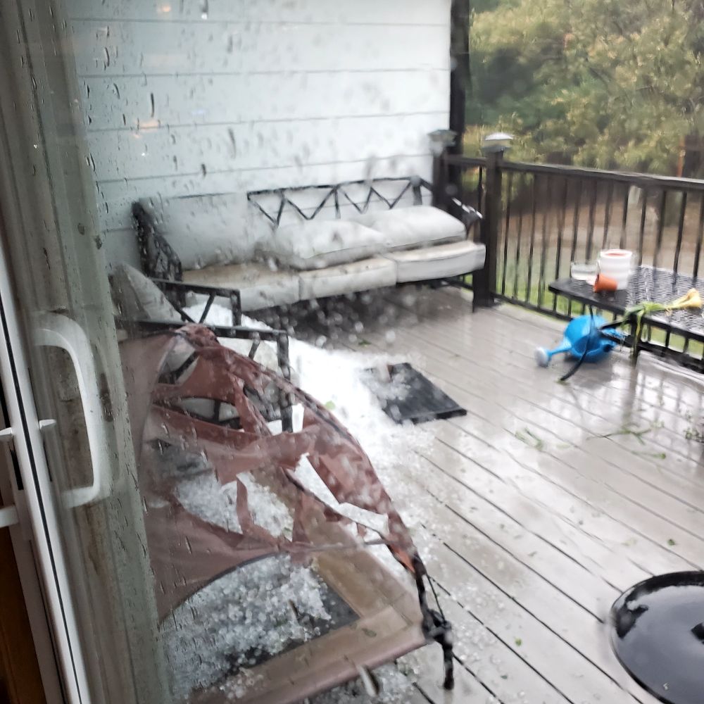 Deck covered in ice and rain with torn dog bed 