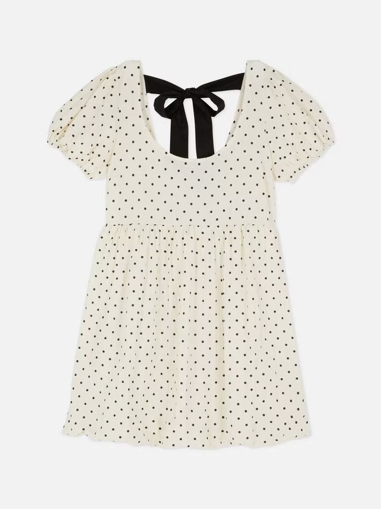 white polka dot dress with bubble hem & a black bow on the back
